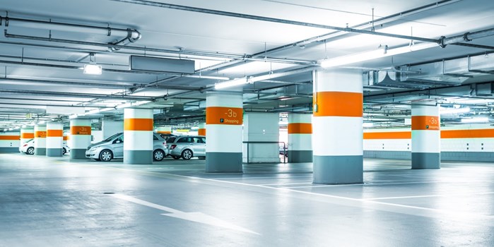 Several cars preparing to park in a multi-storey car park.