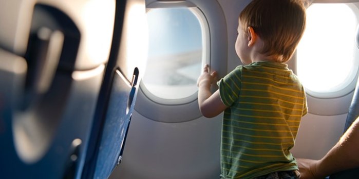 A child looking out of a plane window